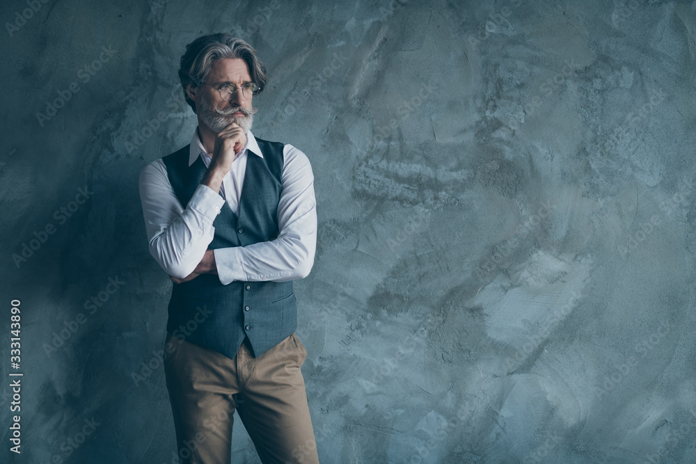 Portrait of minded old rich wealthy man look copy space touch chin hands think thoughts about successful company enterprise wear stylish lifestyle clothes isolated grey color background Portrait of minded old rich wealthy man look copy space touch chin hands think thoughts about successful company enterprise wear stylish lifestyle clothes isolated grey color background