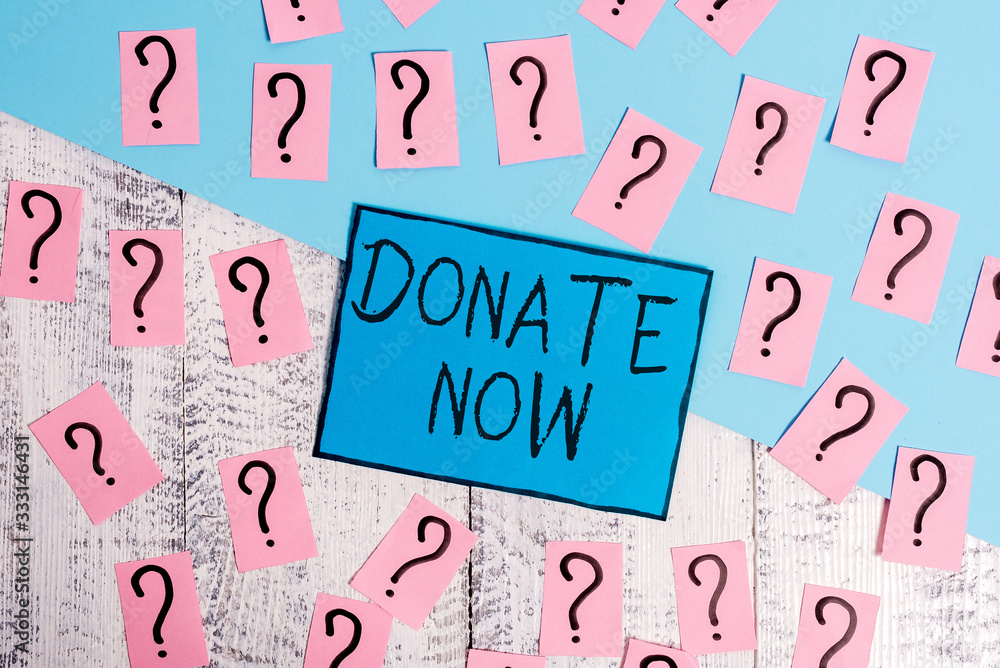 Text sign showing Donate Now. Business photo text to give something like money or goods to a charity or any cause Scribbled and crumbling papers with thick cardboard above wooden table Text sign showing Donate Now. Business photo text to give something like money or goods to a charity or any cause Scribbled and crumbling papers with thick cardboard above wooden table