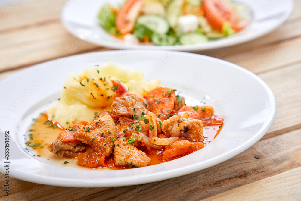 chicken with mashed potatoes and salad on the wooden background chicken with mashed potatoes and salad on the wooden background