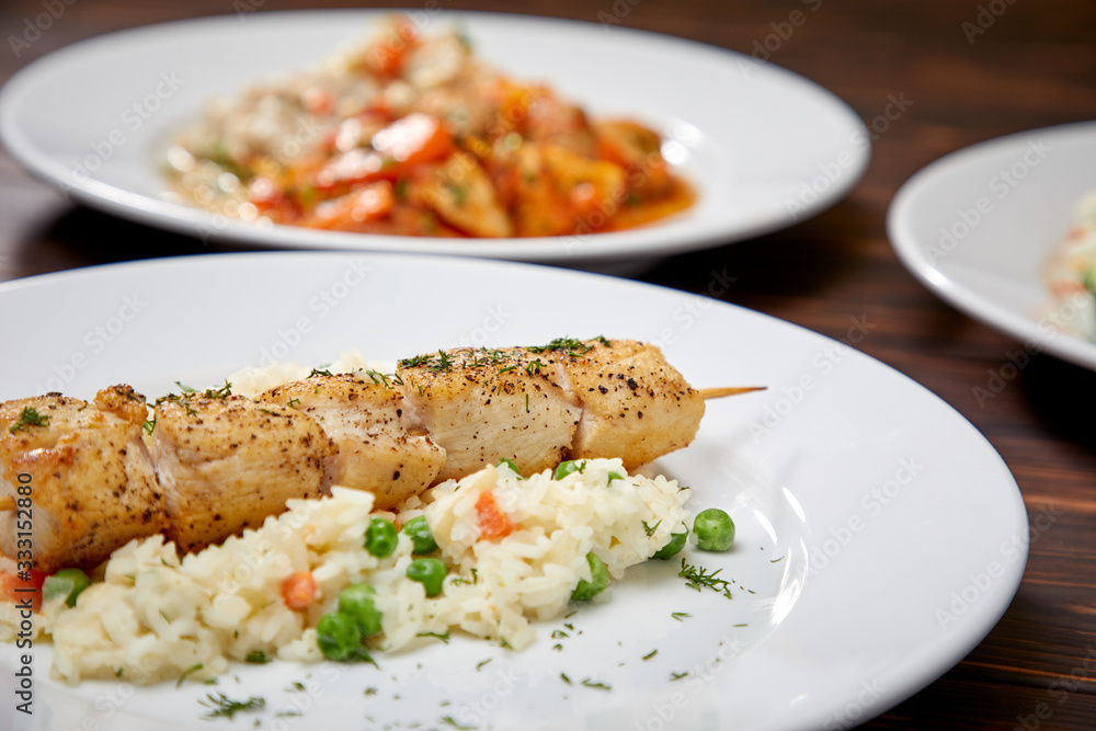 chicken kebab with rice and vegetables on the wooden background chicken kebab with rice and vegetables on the wooden background