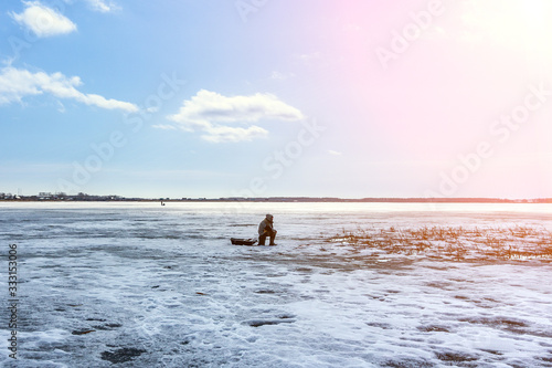 fisherman on a winter fishing trip sits on the lake. fishing, winter sports travel