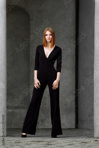 Canvas-taulu Full length portrait of red hair girl in black jumpsuit