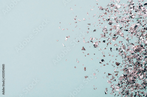 Silver stars glitter on a light pastel background