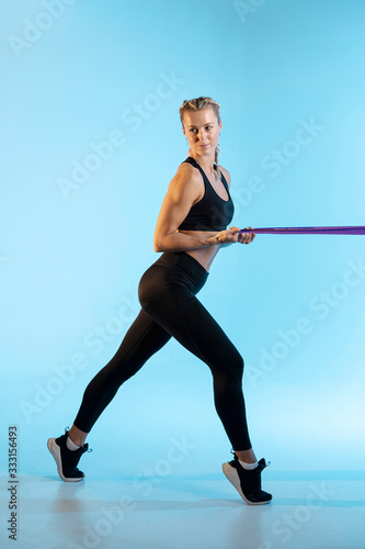 Side view woman exercising with elastic band