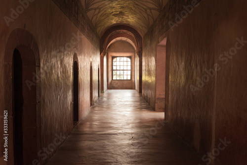 Corridor with window at the end of the cloister in Actopan Mexic
