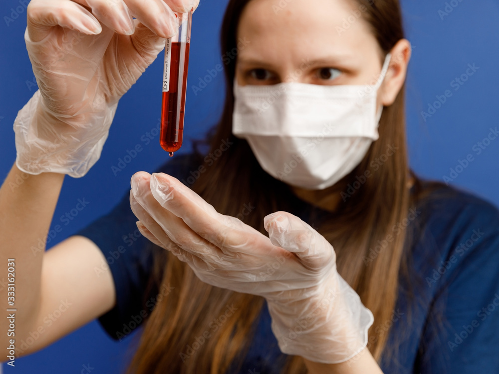 Nurse holding test tube with blood for virus analyzing. COVID-19 and coronavirus identification. Empty space isolated on blue background.