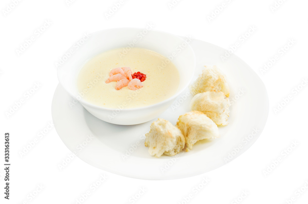 Vegetable cream soup with shrimps and croutons in white bowl Vegetable cream soup with shrimps and croutons in white bowl