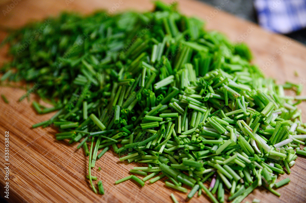 Fresh green chive chopped on wooden table Fresh green chive chopped on wooden table