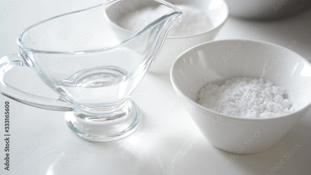 Almond flour, sugar and water on white table. Chef takes ingredients for making french macarons. Cooking macaroon. Almond flour, sugar and water on white table. Chef takes ingredients for making french macarons. Cooking macaroon.