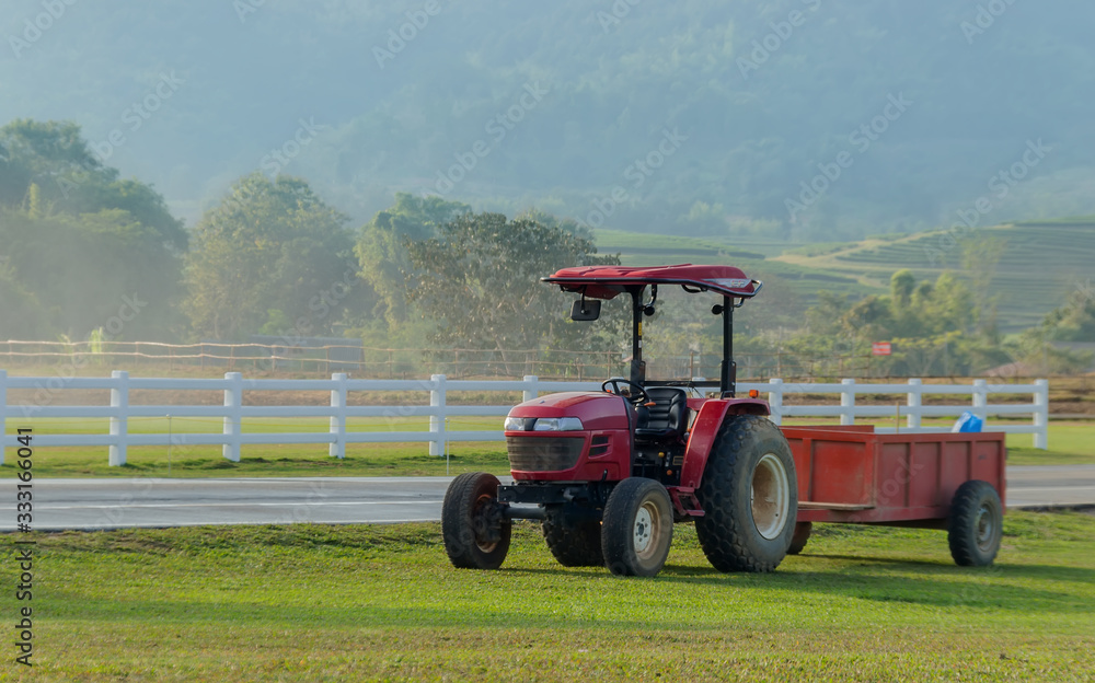 Fototapeta premium red tractor car on farm in agriculture