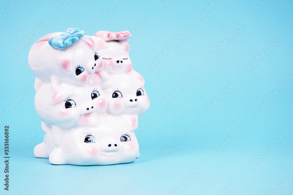 Ceramic piggy bank piggy for money. Photographed on a blue background, flat lay Ceramic piggy bank piggy for money. Photographed on a blue background, flat lay