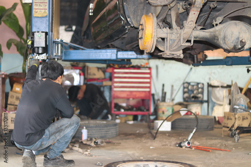 The mechanic is checking the engine.