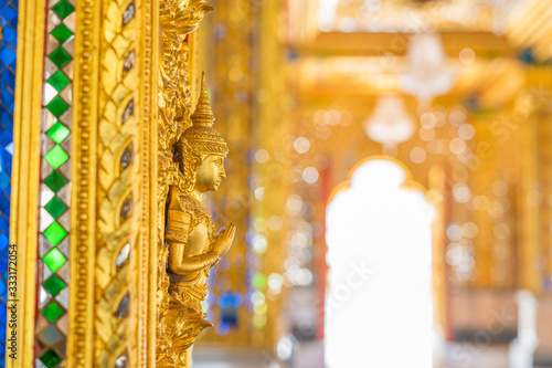 Wood carving of the gods and decorated with stained glass Beautifully decorated the temple interior at Wat Chantraram or Tha Sung Temple, Uthai Thani, Thailand