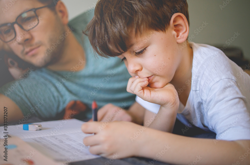 Father homeschooling his son Father homeschooling his son
