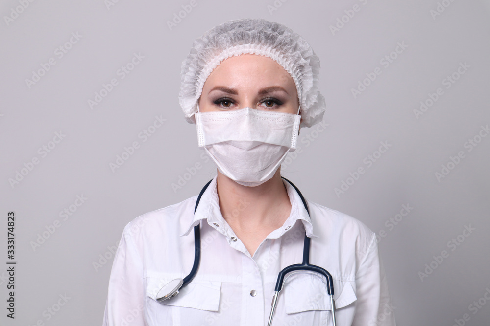 Female doctor in a protective medical mask. Pandemic virus COVID-19 Female doctor in a protective medical mask. Pandemic virus COVID-19
