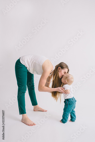 Portrait of happy mother with her little baby in her room.