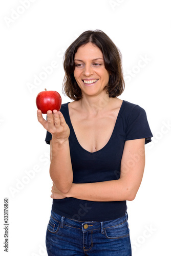 Studio shot of happy woman holding apple isolated against white background