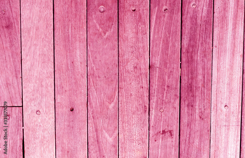 Bright pink wooden backdrop, boards. Red tinted wood. Fragment of fence, floor or wall of building made of wooden boards, place for text. Copy space. Bright pink wooden backdrop, boards. Red tinted wood. Fragment of fence, floor or wall of building made of wooden boards, place for text. Copy space.
