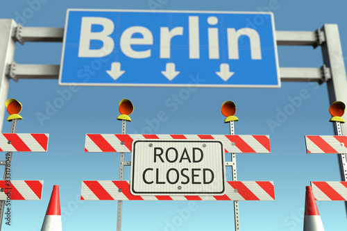 Roadblock near Berlin city traffic sign. Coronavirus disease quarantine or lockdown in Germany conceptual 3D rendering © Alexey Novikov