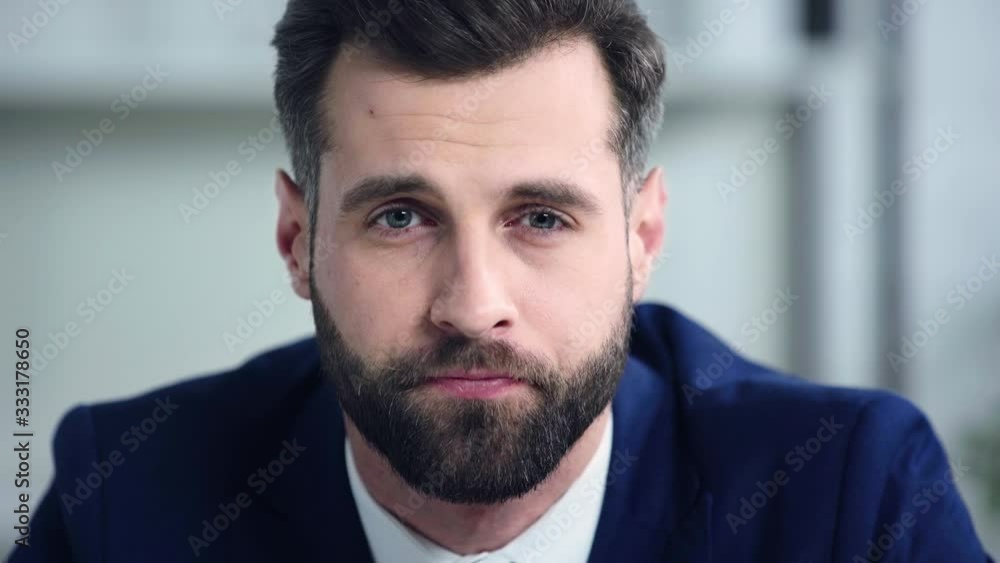sad businessman looking at camera in office sad businessman looking at camera in office