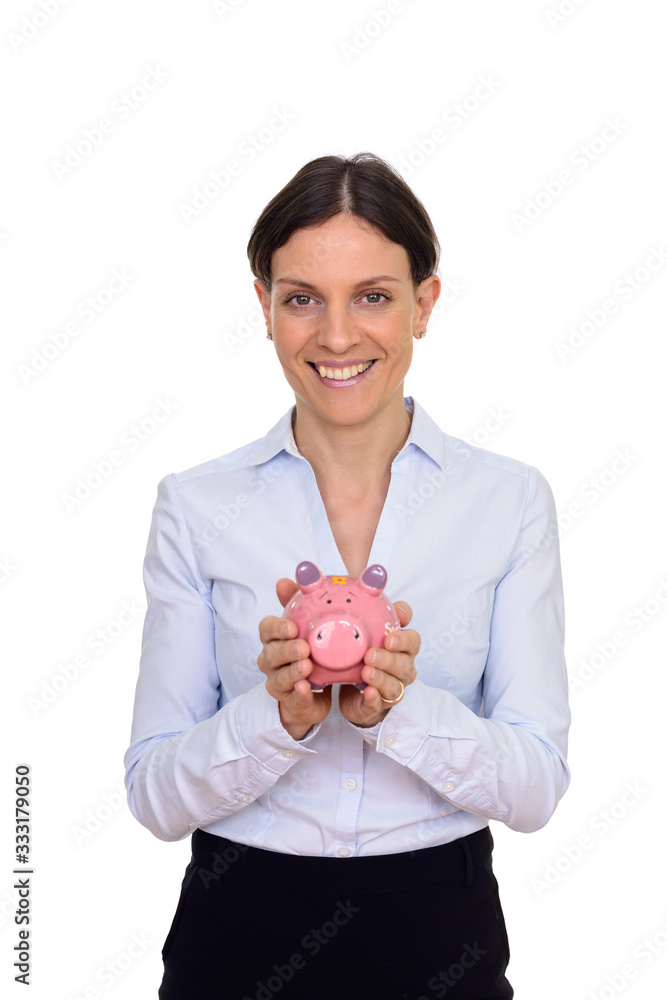 Studio shot of happy woman holding piggy bank isolated against white background Studio shot of happy woman holding piggy bank isolated against white background