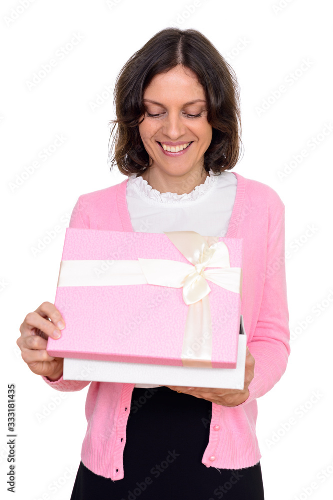 Studio shot of happy woman opening gift box isolated against white background Studio shot of happy woman opening gift box isolated against white background