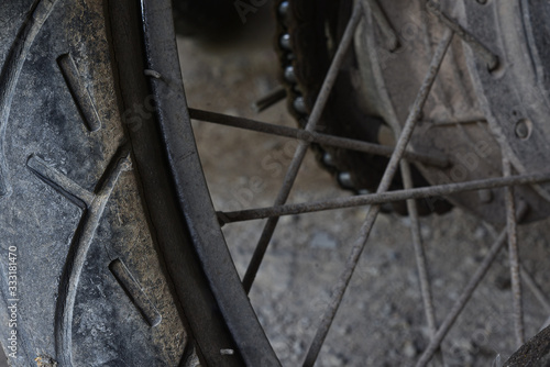 Old motorcycle tires that are cracked and worn