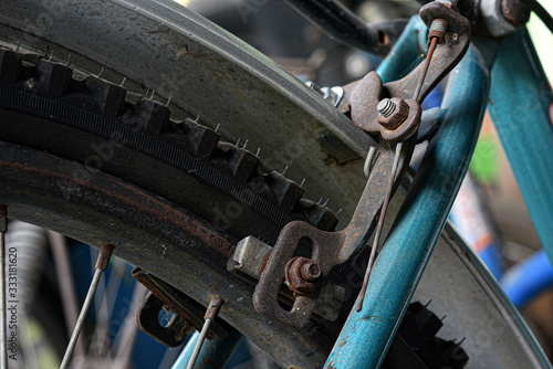 The old brake system of the bicycle is full of rust stains.
