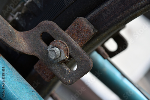 The old brake system of the bicycle is full of rust stains.