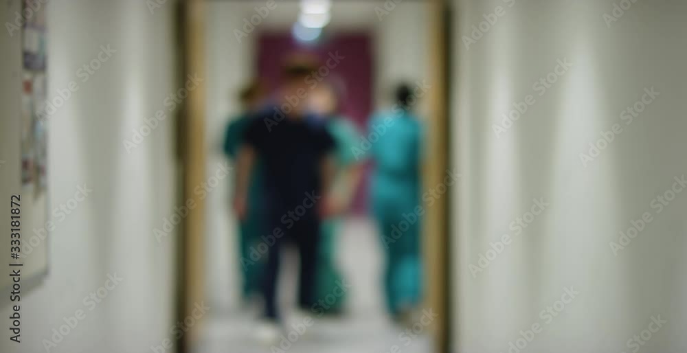 Blurred Medical Staff In Hospital Corridor Blurred Medical Staff In Hospital Corridor