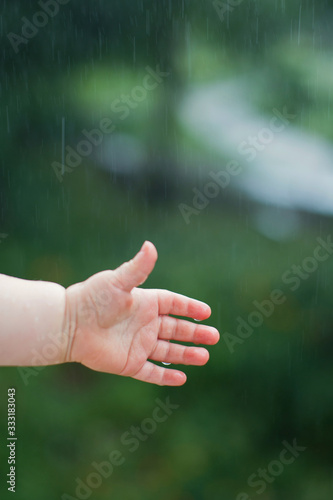 Little child hand catch the rain drops © aprilante