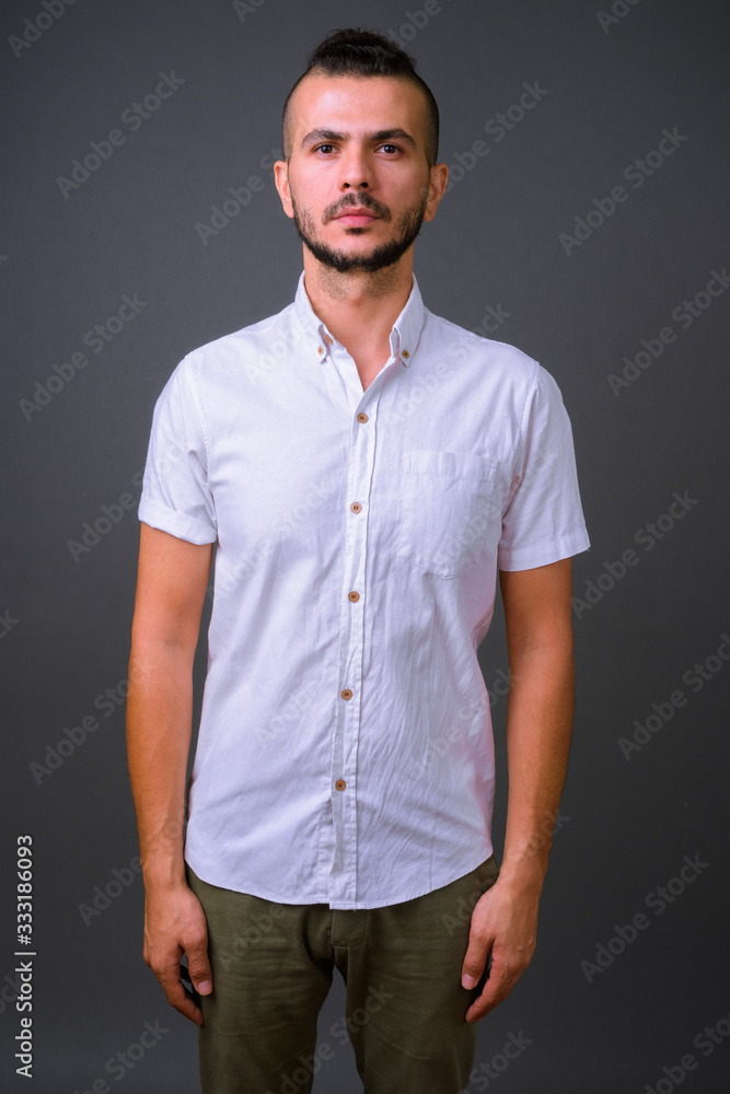 Portrait of handsome bearded Turkish man looking at camera Portrait of handsome bearded Turkish man looking at camera