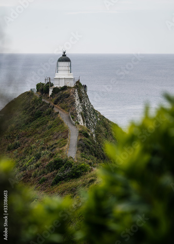 nugget point lighthouse on the coast of new zealand photo