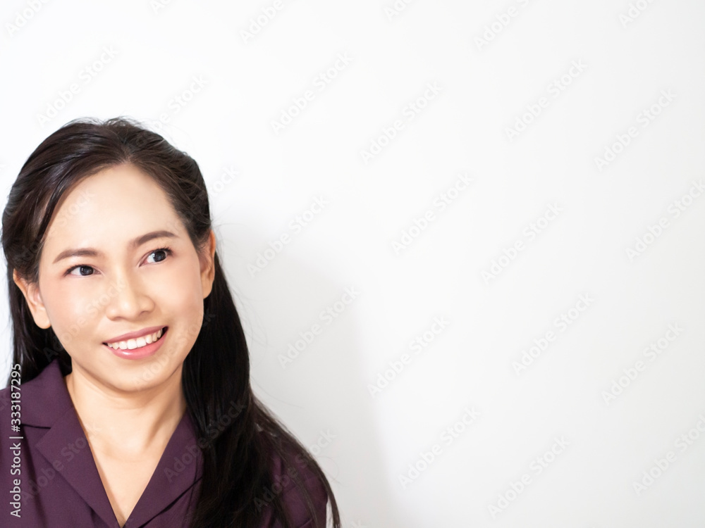 One happy and confidence asian bussiness woman has dark brown long hair and wear violet shirt. She is smilling and acting emotion look at space. Copy space for wording white background. Service mind. One happy and confidence asian bussiness woman has dark brown long hair and wear violet shirt. She is smilling and acting emotion look at space. Copy space for wording white background. Service mind.