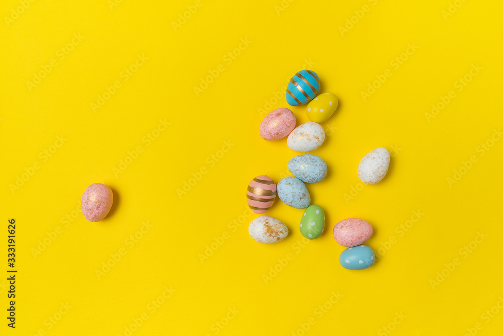 Different colorful Easter eggs on yellow background, top view. Holiday eggs Different colorful Easter eggs on yellow background, top view. Holiday eggs