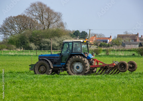 Blue Tractor in a Green Field