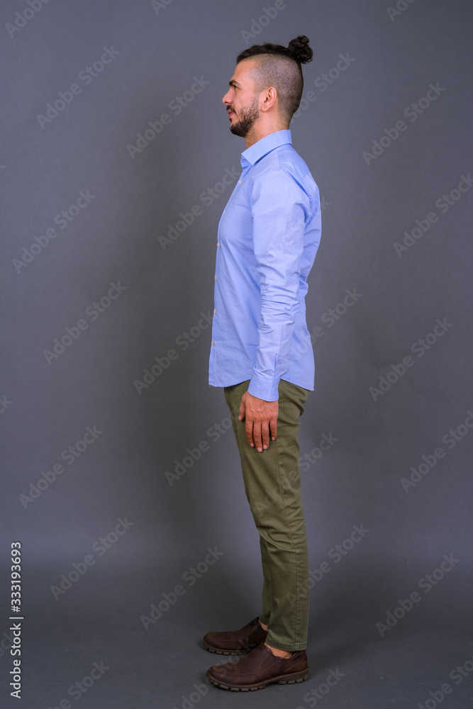 Full body shot profile view of handsome bearded Turkish businessman