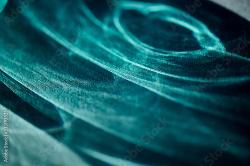 abstract light glow, lens flare, caustics water glas reflections. light through a prism,  turquoise. black background
