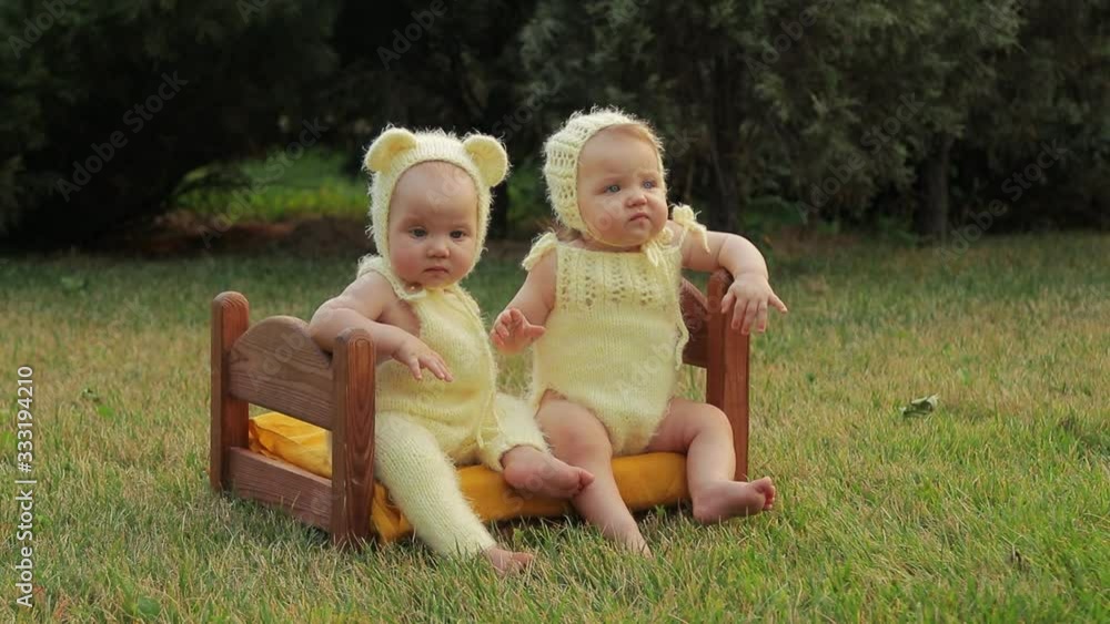Toddlers twins girl and boy in bears costumes in the park Toddlers twins girl and boy in bears costumes in the park