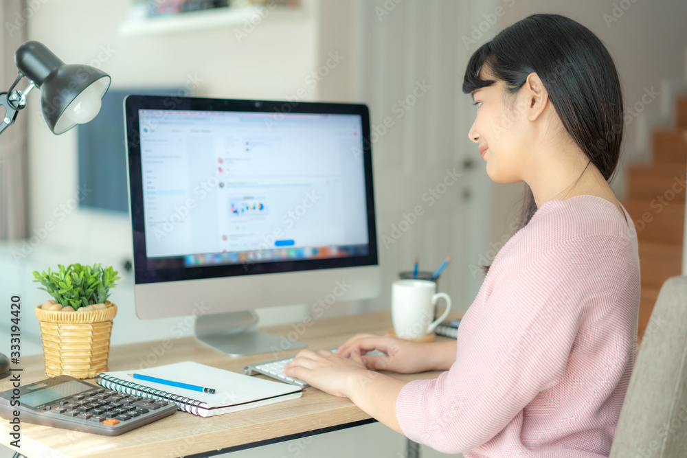 Asian business woman chatting to her colleagues about work plan in chat room. Multiethnic business team using computer for a online meeting. Group of people smart working from home..