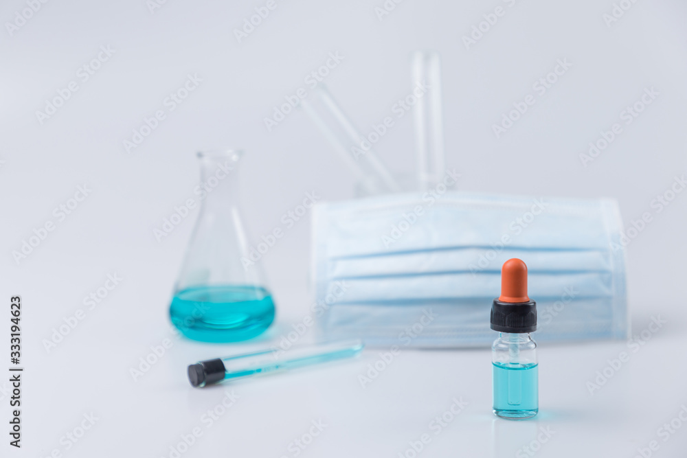 Flask,test tubes,dropper,mask with lab glassware in chemical and science laboratory , medical tools. Research and development concept. Flask,test tubes,dropper,mask with lab glassware in chemical and science laboratory , medical tools. Research and development concept.