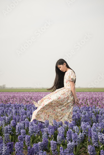 Portrait of asian girl in flowerfield photo