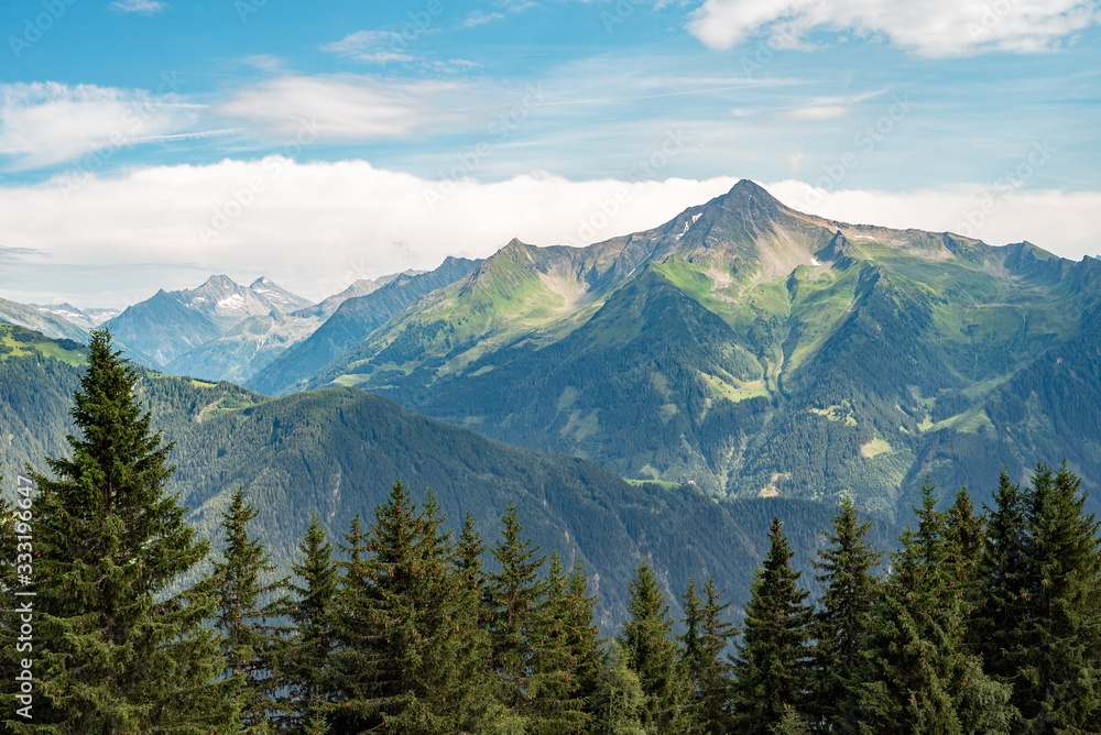 Panoramic view of the famous mountain peaks glowing in the beautiful golden sunlight in summer, Zillertal Austria. In the background the Great Venetian Panoramic view of the famous mountain peaks glowing in the beautiful golden sunlight in summer, Zillertal Austria. In the background the Great Venetian