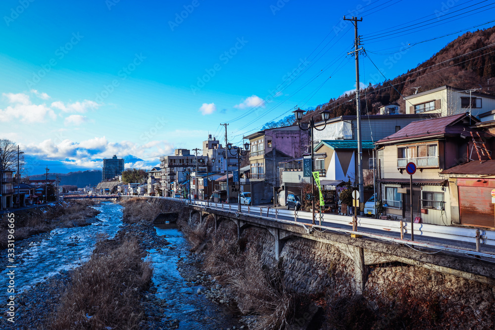 Yudanaka, Japan - January 05, 2020:  View to the mount River in the Small Station City near Nagano