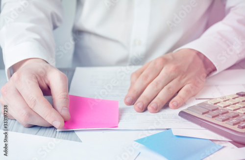 Businessman works with papers. Close-up of the hands of a working man. Work with checks, taxes and bills. Brainstorm. Business goals