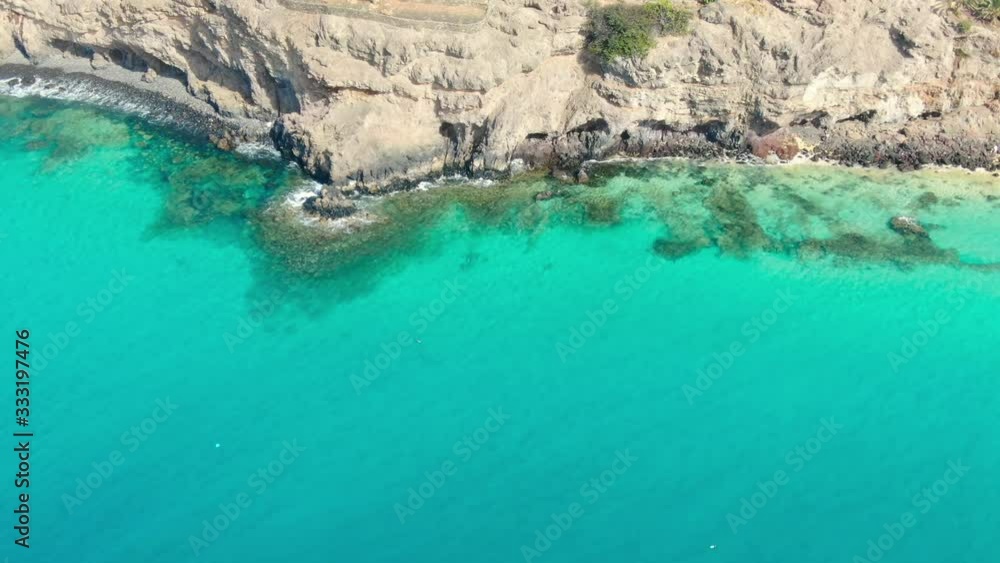 Aerial view on Cliff and coast of Atlantic Ocean, Crystal Clear turquoise water, Waves on Sea, Fuerteventura, Canary Islands, Spain Aerial view on Cliff and coast of Atlantic Ocean, Crystal Clear turquoise water, Waves on Sea, Fuerteventura, Canary Islands, Spain