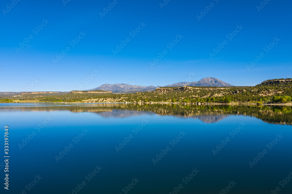 Panorama view of landscape american nature. Blue sky and lake, mountains reflection in water. Recapture reservoir in Utah state, USA country