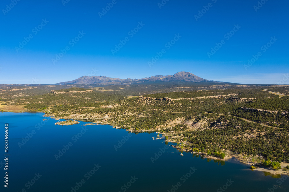 Aerial view of landscape american nature. Blue sky and lake,  mountains reflection in water. Recapture reservoir. Utah, USA