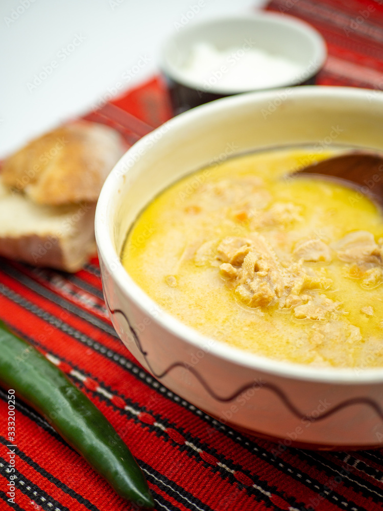 traditional romanian dish tripe soup known as ciorba de burta served with cream and pepper traditional romanian dish tripe soup known as ciorba de burta served with cream and pepper