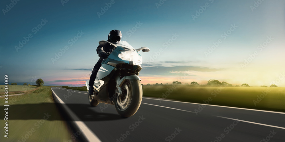Rapid motorbike ride on the country road at the most beautiful sunset. Adventure and motor sport.